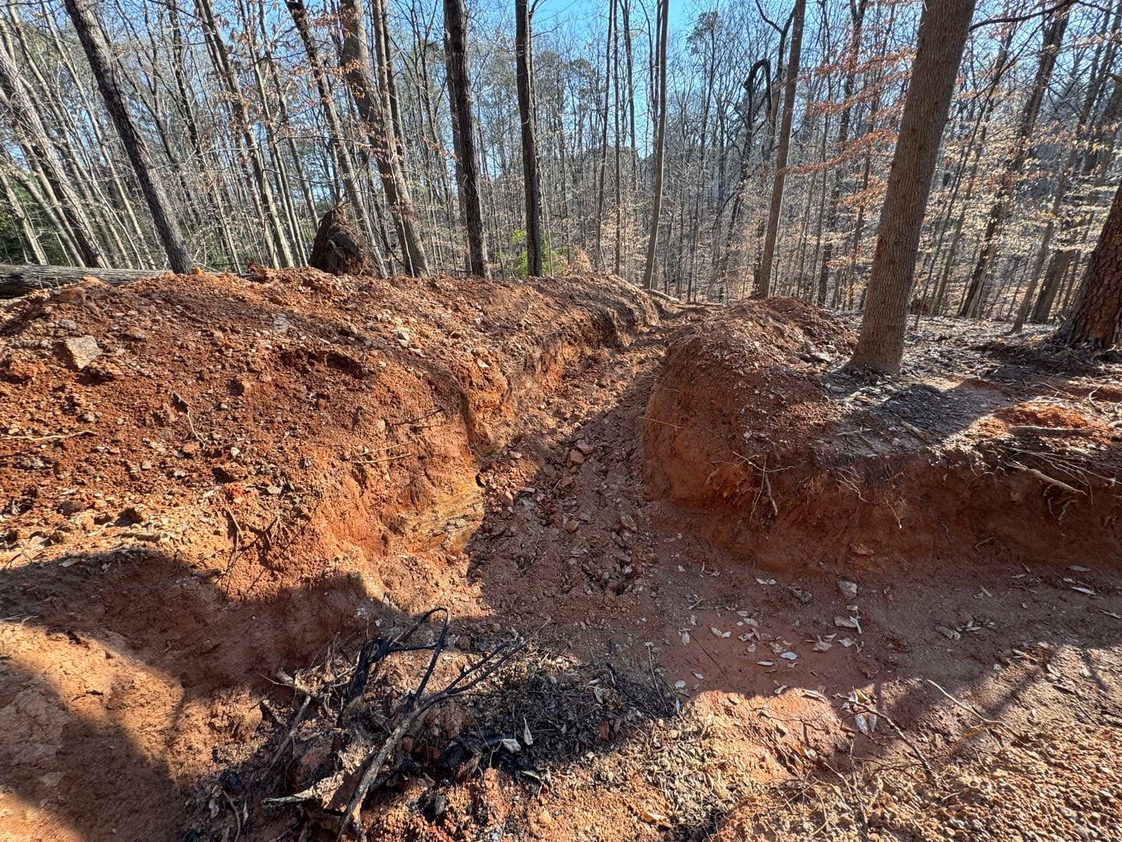 Freshly dug trench through red Georgia clay